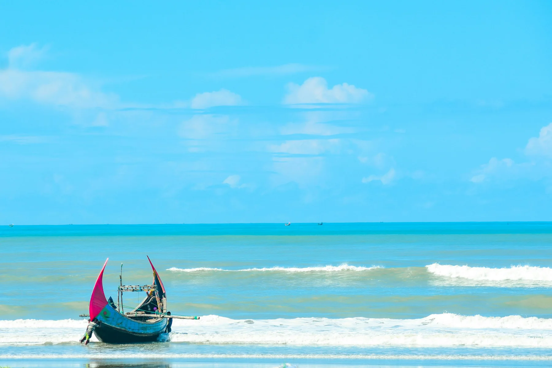 A small boat beside a tropical shore.